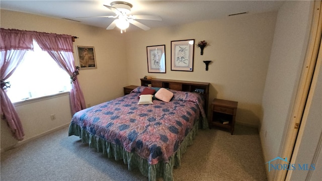 carpeted bedroom with ceiling fan and a closet