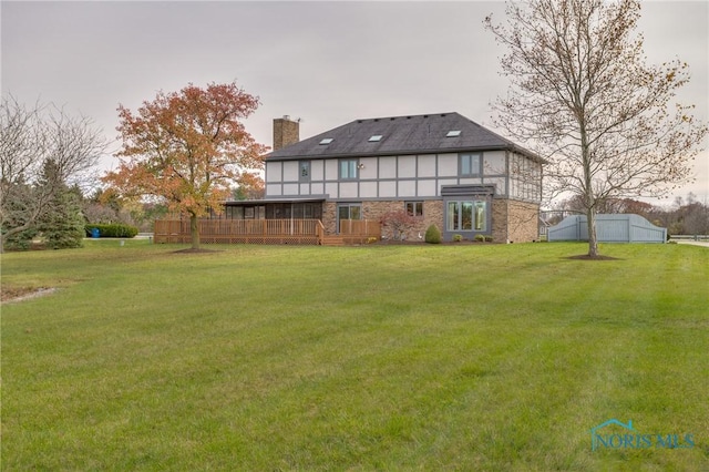 7733 Brown Rd, Curtice, OH 43412 - rear view of house featuring a chimney, a yard, and a wooden deck