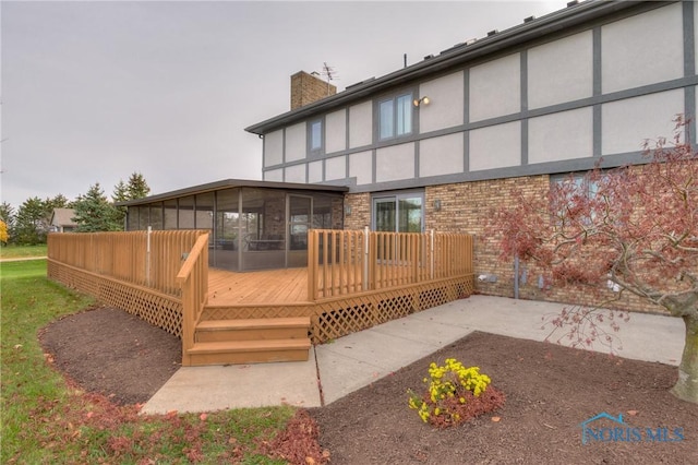 7733 Brown Rd, Curtice, OH 43412 - rear view of house with a sunroom, a chimney, stucco siding, a deck, and a patio