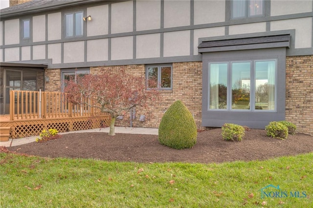 7733 Brown Rd, Curtice, OH 43412 - view of property exterior with brick siding, a deck, and stucco siding