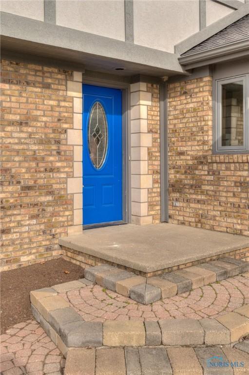 7733 Brown Rd, Curtice, OH 43412 - doorway to property with brick siding and stucco siding