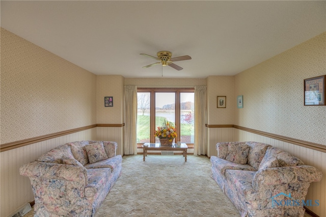 carpeted living room featuring ceiling fan