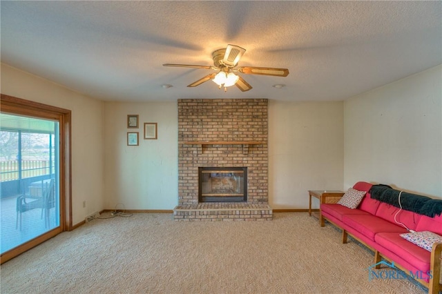 7733 Brown Rd, Curtice, OH 43412 - carpeted living room featuring ceiling fan, a textured ceiling, a fireplace, and baseboards
