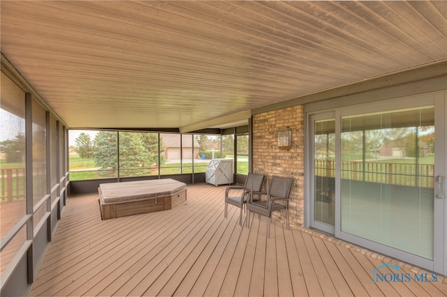 unfurnished sunroom featuring wooden ceiling and a wealth of natural light