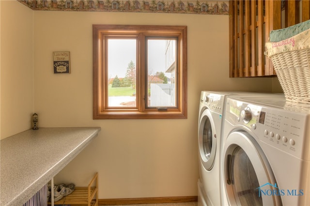 clothes washing area with washer and clothes dryer