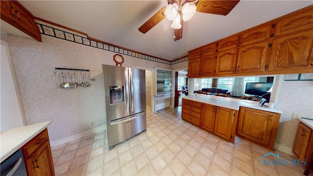 kitchen featuring stainless steel appliances, ceiling fan, radiator heating unit, and lofted ceiling