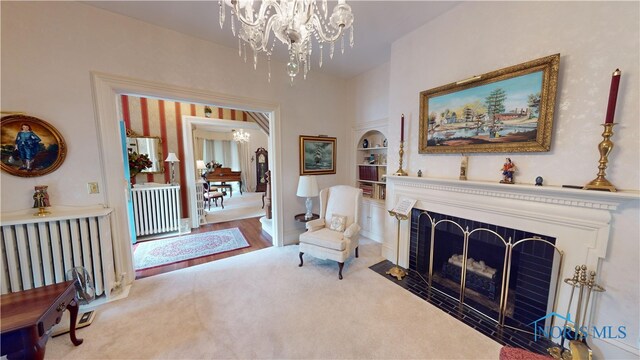 sitting room with wood-type flooring and a chandelier