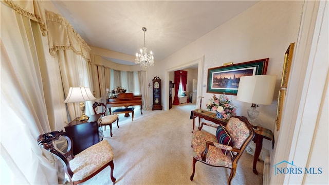 living area featuring light carpet and a notable chandelier