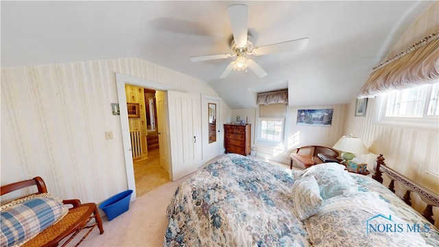 bedroom featuring ceiling fan, light carpet, and vaulted ceiling