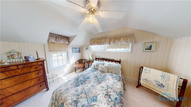 bedroom with ceiling fan, light carpet, and lofted ceiling