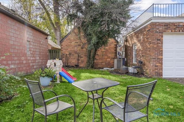 view of yard with central AC unit and a playground