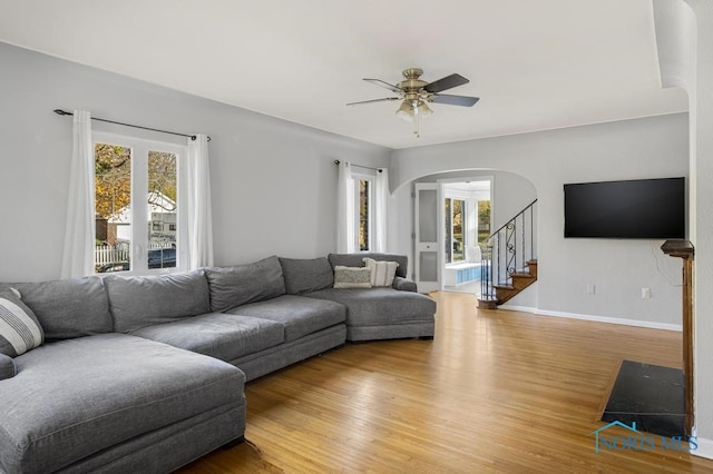 living room featuring hardwood / wood-style floors, ceiling fan, and plenty of natural light