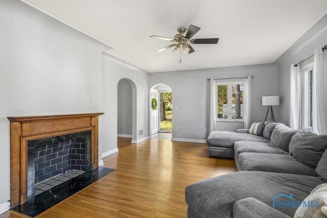 living room with ceiling fan and light hardwood / wood-style flooring