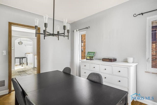 dining room featuring light hardwood / wood-style floors and a notable chandelier