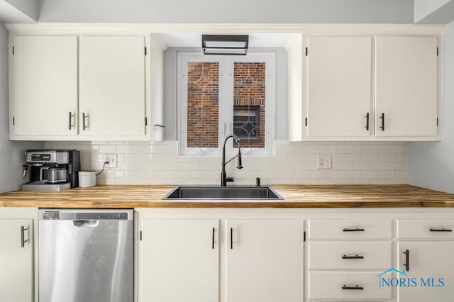 kitchen with dishwasher, decorative backsplash, white cabinetry, and sink