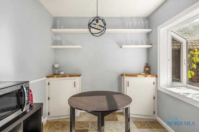 dining space featuring indoor bar