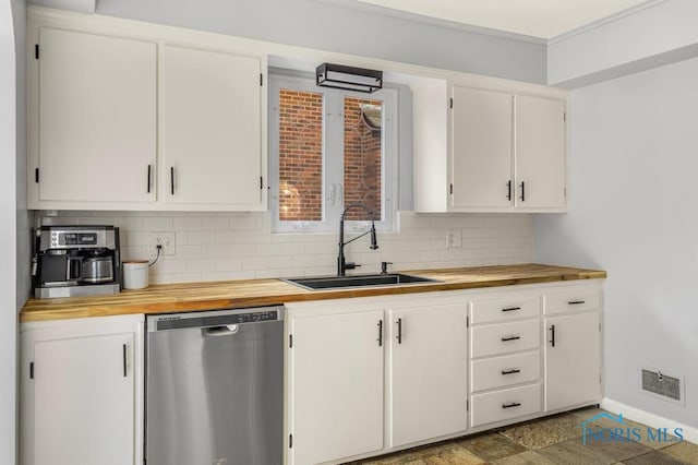 kitchen with dishwasher, butcher block countertops, white cabinets, and sink