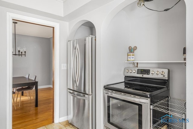 kitchen with stainless steel appliances and light hardwood / wood-style floors