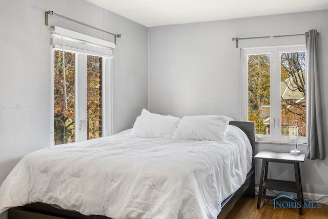 bedroom with dark wood-type flooring