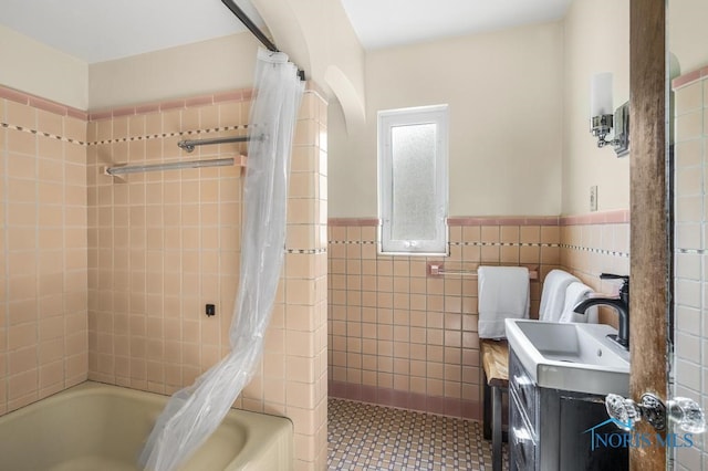 bathroom featuring tile walls, vanity, tile patterned floors, and shower / bathtub combination with curtain