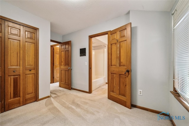 carpeted bedroom with a closet and a textured ceiling