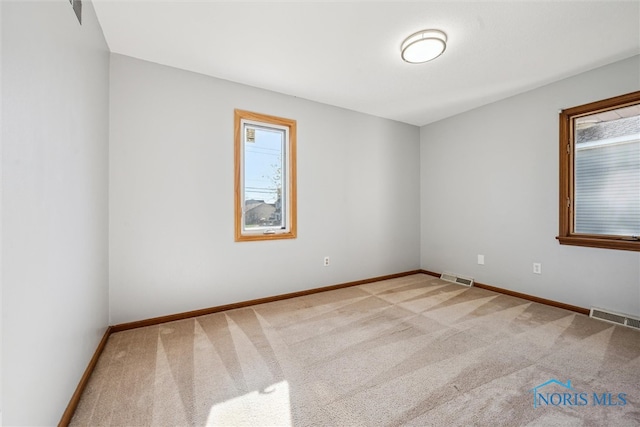 empty room with light colored carpet