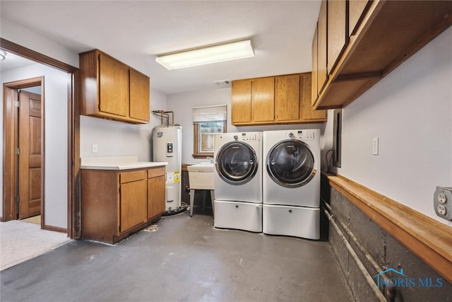 laundry room featuring electric water heater, cabinets, sink, and independent washer and dryer