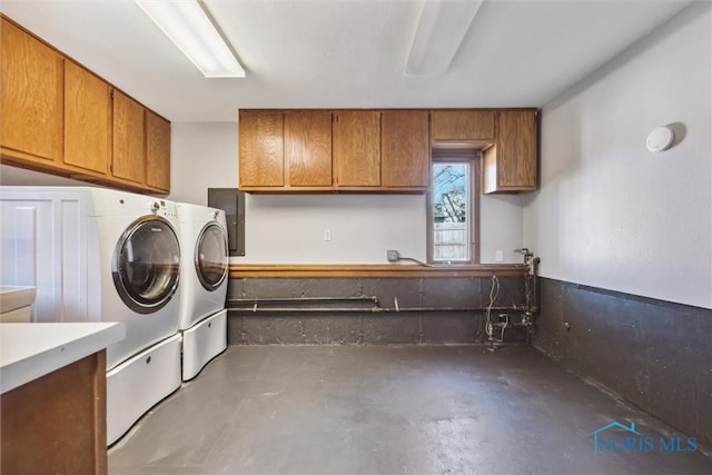 washroom with cabinets and washer and clothes dryer