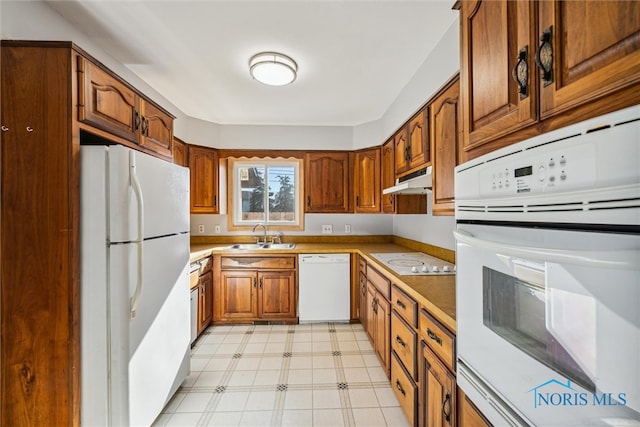 kitchen featuring white appliances and sink