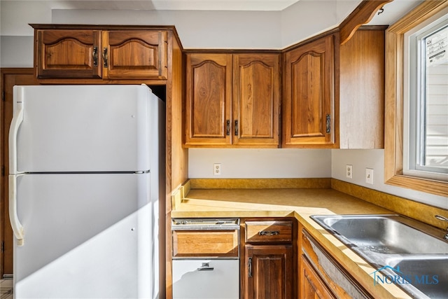 kitchen featuring sink and white fridge