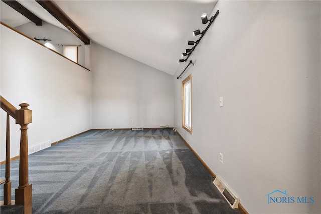 interior space featuring a barn door, beamed ceiling, carpet flooring, and high vaulted ceiling