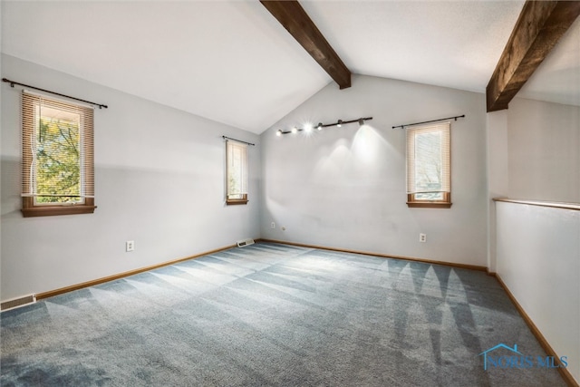 spare room featuring carpet flooring and vaulted ceiling with beams