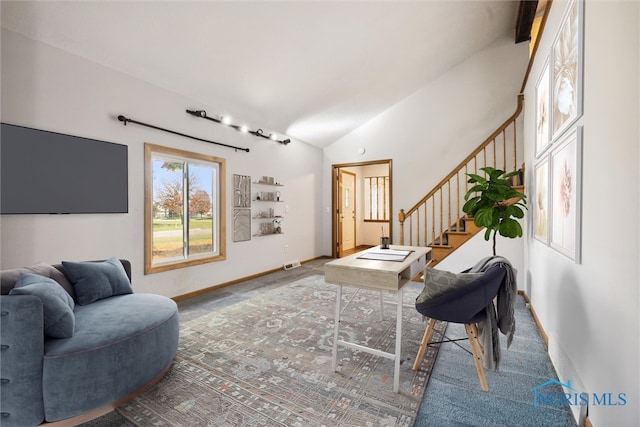 living room with carpet flooring and high vaulted ceiling