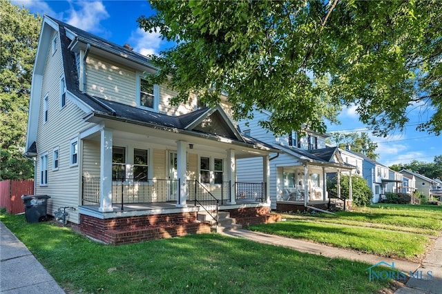 view of front of house featuring a front lawn and covered porch