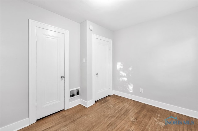 spare room featuring light wood-type flooring