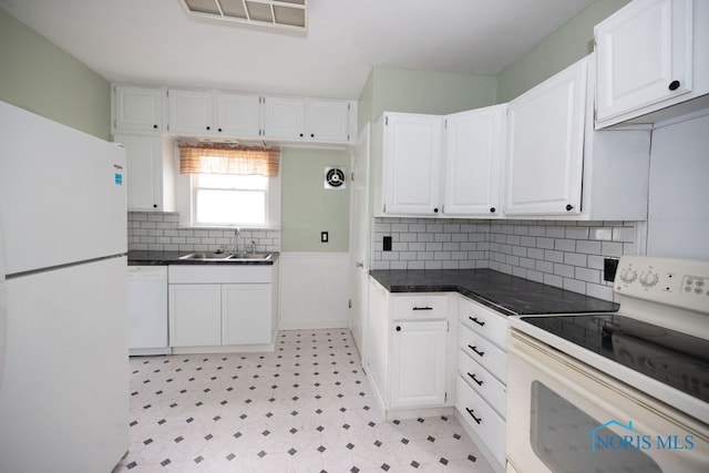 kitchen with white cabinets, white appliances, and sink