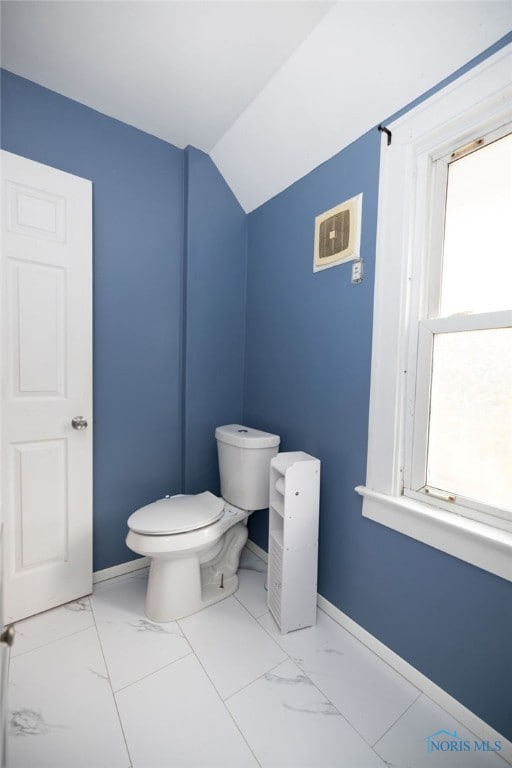 bathroom with vaulted ceiling and toilet