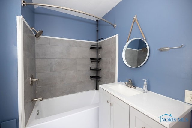 bathroom with tiled shower / bath combo and vanity