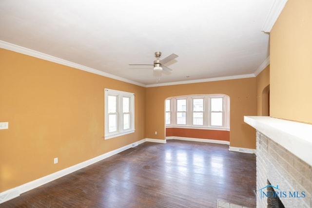 unfurnished living room featuring plenty of natural light, dark wood-type flooring, and ornamental molding