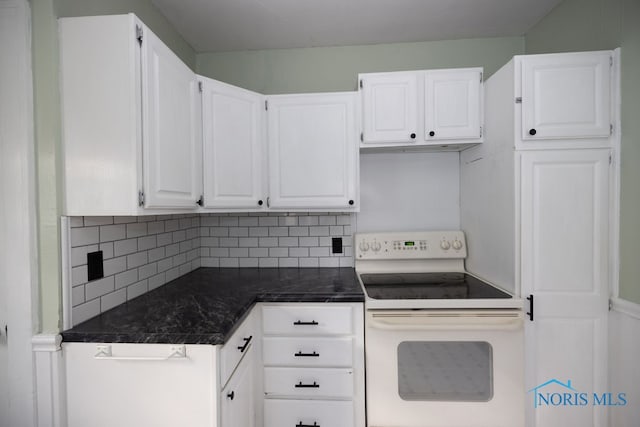 kitchen featuring tasteful backsplash, electric stove, white cabinets, and dark stone counters