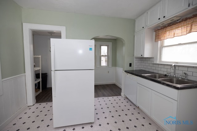 kitchen with white appliances, white cabinetry, plenty of natural light, and sink