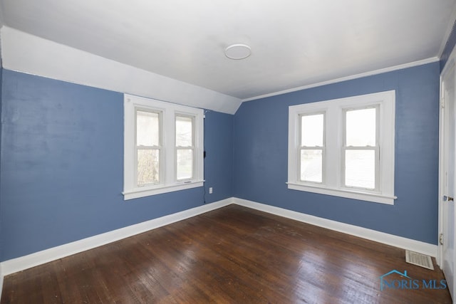 empty room featuring dark hardwood / wood-style floors and crown molding