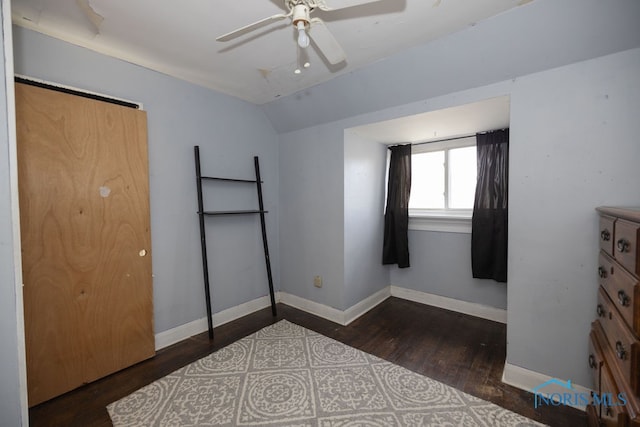 bedroom with ceiling fan, dark hardwood / wood-style flooring, and lofted ceiling