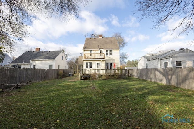 back of property featuring a lawn, a balcony, and a wooden deck