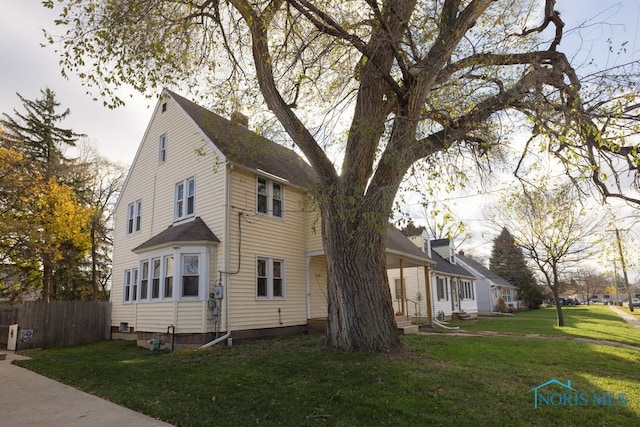 view of home's exterior with a lawn