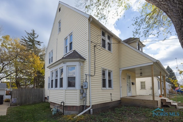 rear view of property with a porch