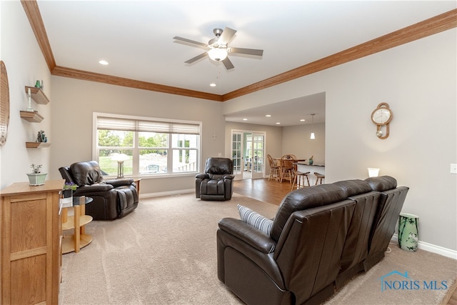 living room featuring ceiling fan, carpet, and ornamental molding