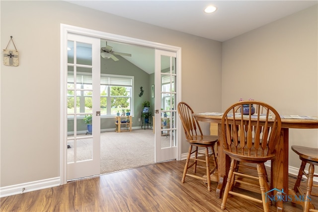 dining room with french doors, ceiling fan, vaulted ceiling, and wood-type flooring