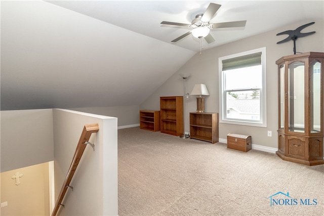 additional living space featuring light carpet, ceiling fan, and vaulted ceiling