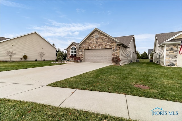 view of front of house featuring a garage and a front lawn